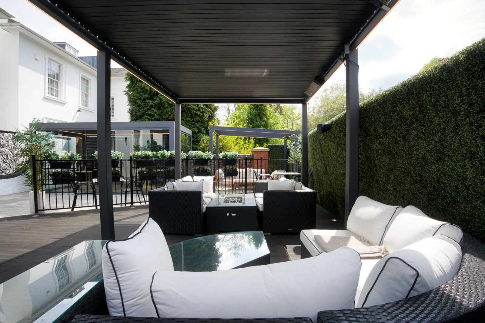 Louvered roof pergolas over an outdoor lounge