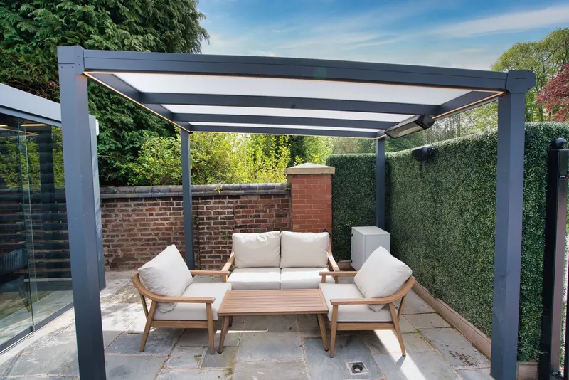 Deponti Bosco veranda with opal roof over a lounge seating area beside a brick wall