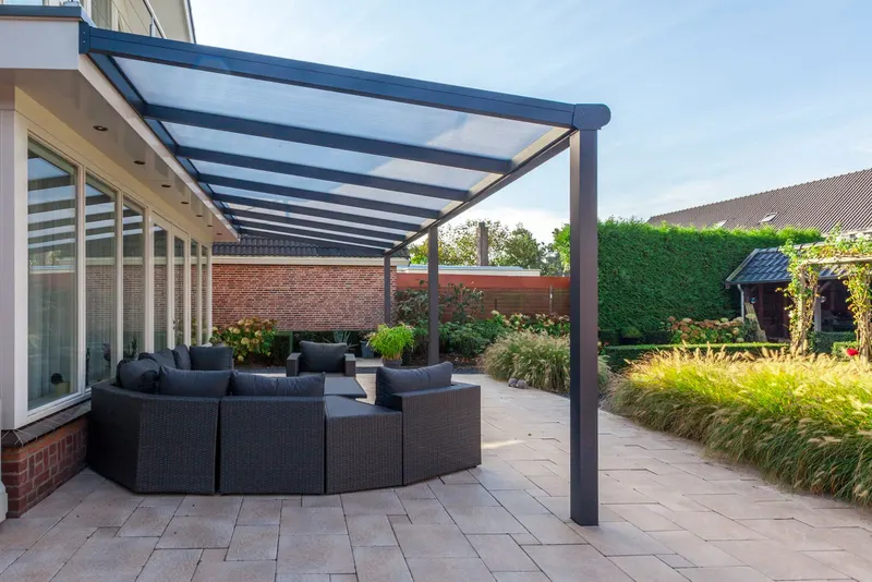 Long Deponti Bosco veranda sheltering an outdoor sofa set alongside a single storey house