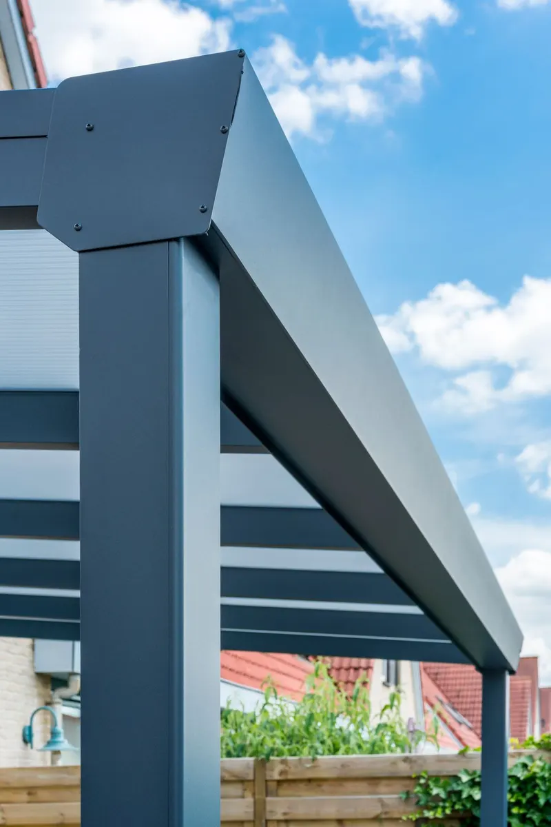 Close view of a Deponti Giallo veranda gutter and post against a blue sky