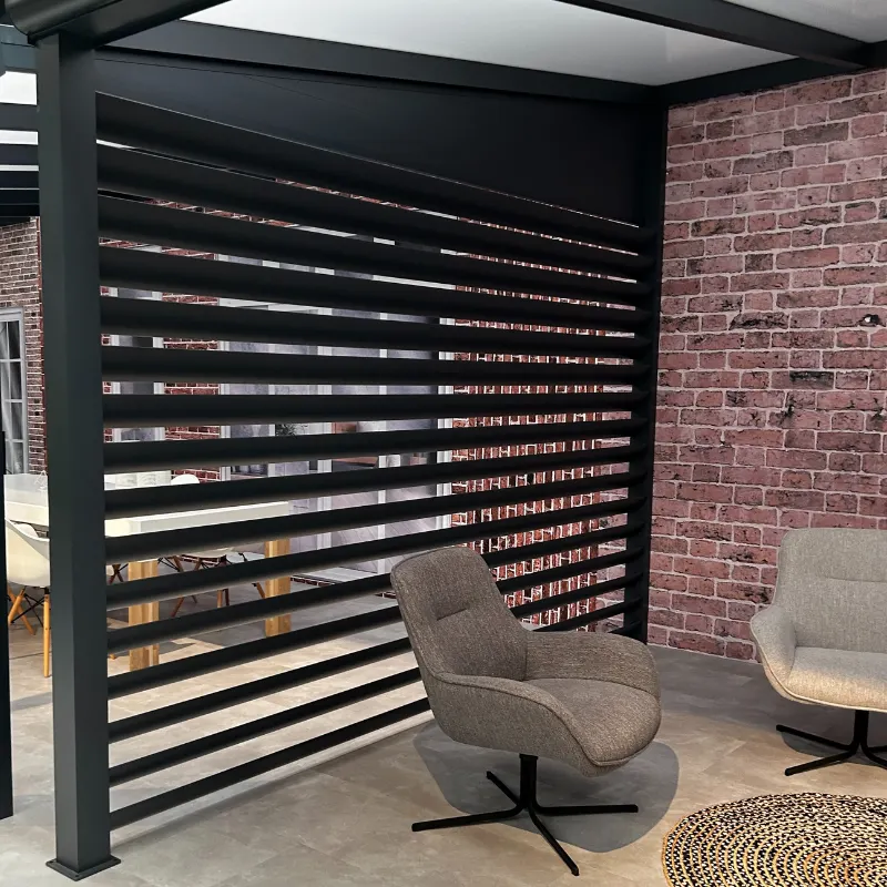 Deponti Louvres wall of black horizontal slats beside a brick wall with lounge chairs