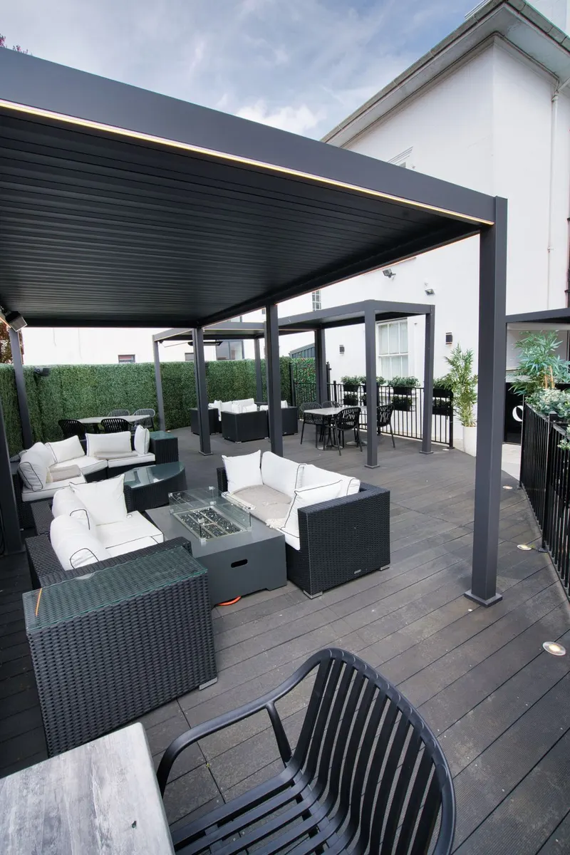 Deponti Pinela louvred roof over rattan lounge furniture on a composite deck