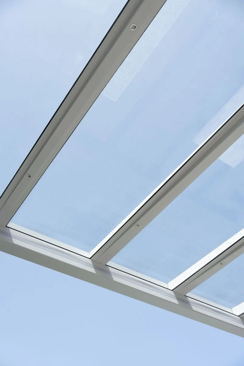 Looking up through the glass roof panels and white frame of a Deponti Pinela Glass