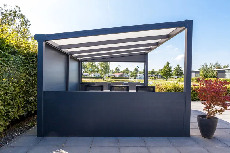Deponti Ribolla solid lower wall panels along a veranda on a sunny paved terrace