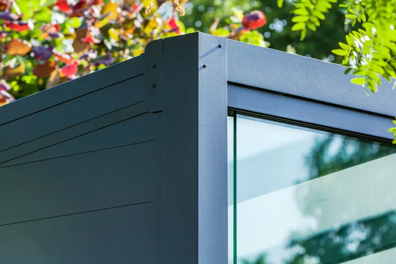 Detail of a Deponti Ribolla grey wall panel meeting a glass pane at the corner post