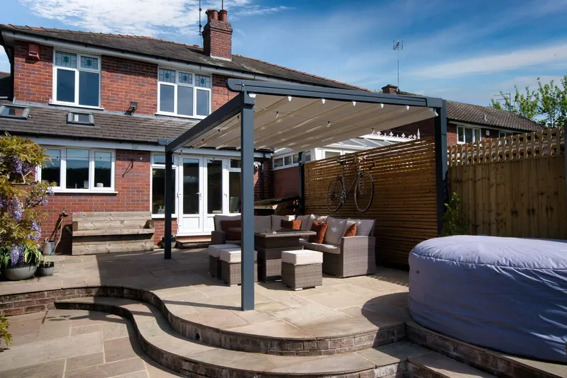 Deponti Verdeca pergola with retractable fabric roof over a patio lounge set