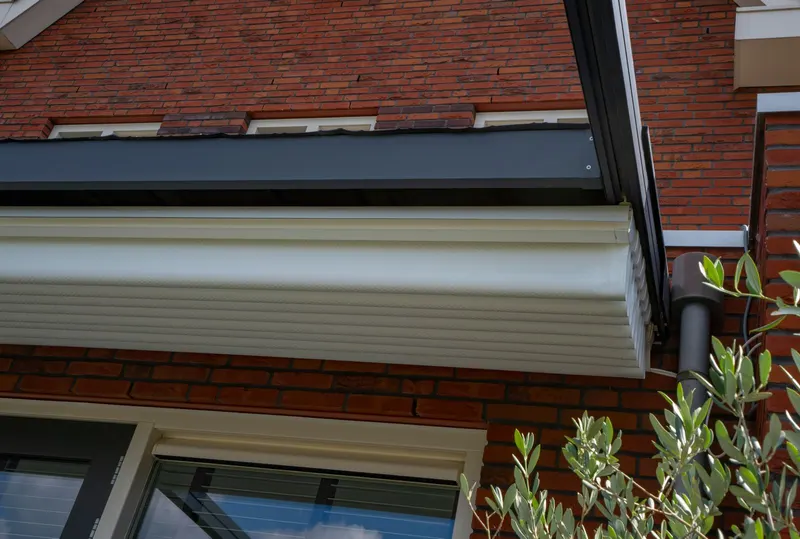 Close up of a Deponti Verdeca white fabric roof folded back against a brick house wall