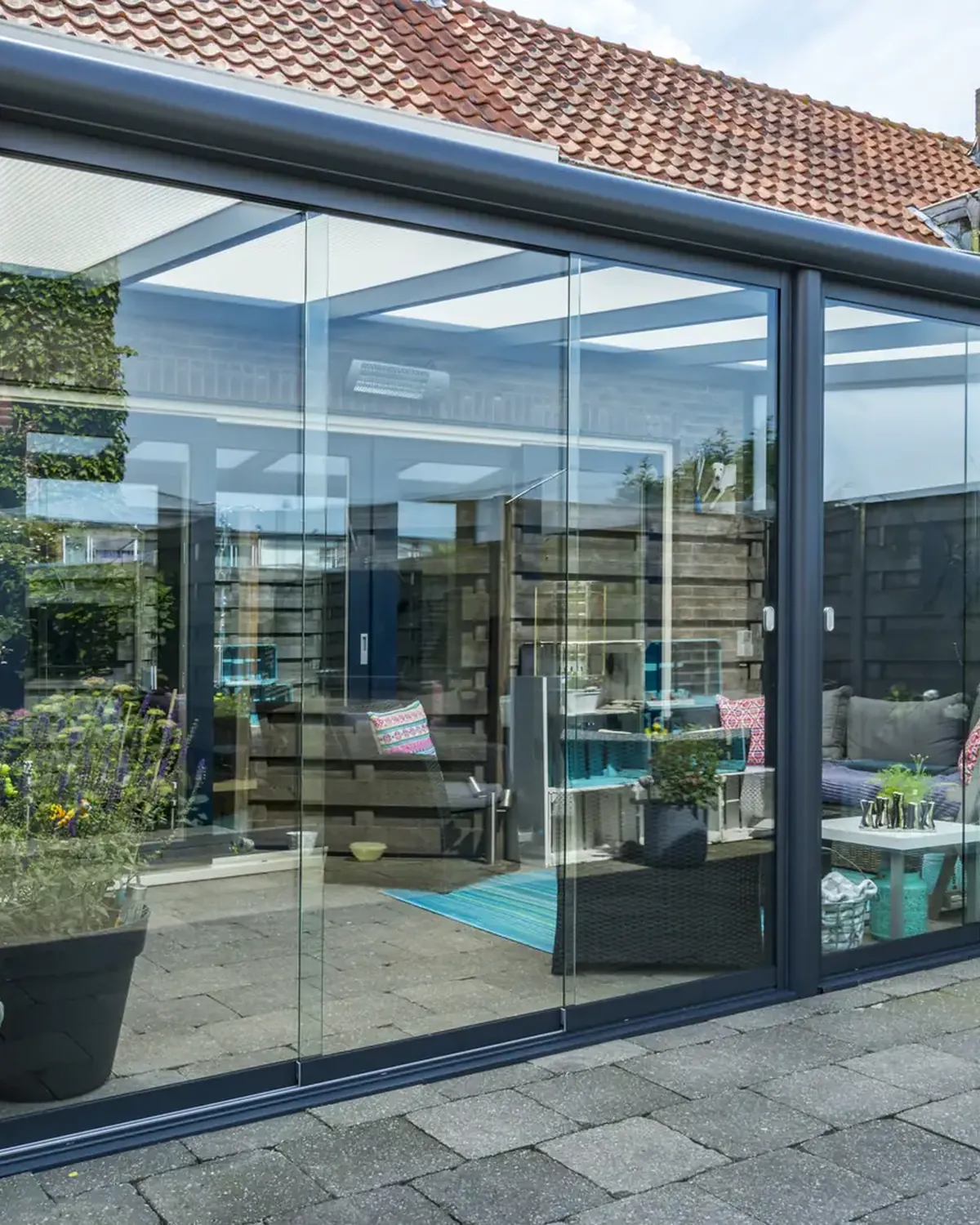 Lean-to veranda with glass sliding doors attached to a brick house
