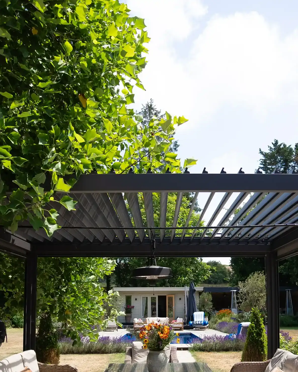 Louvered roof pergolas over an outdoor lounge