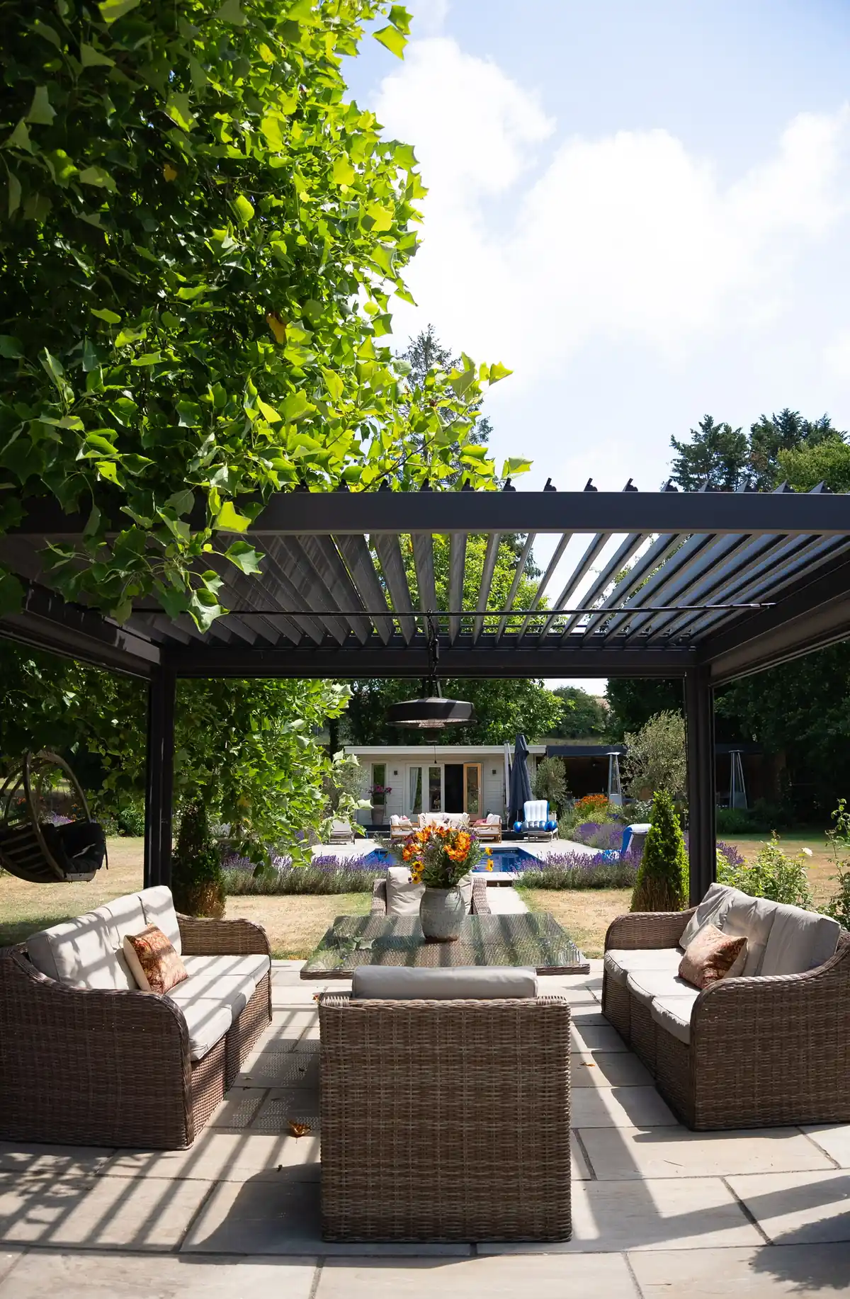 Titan aluminium pergola with an open louvre roof over a poolside seating area
